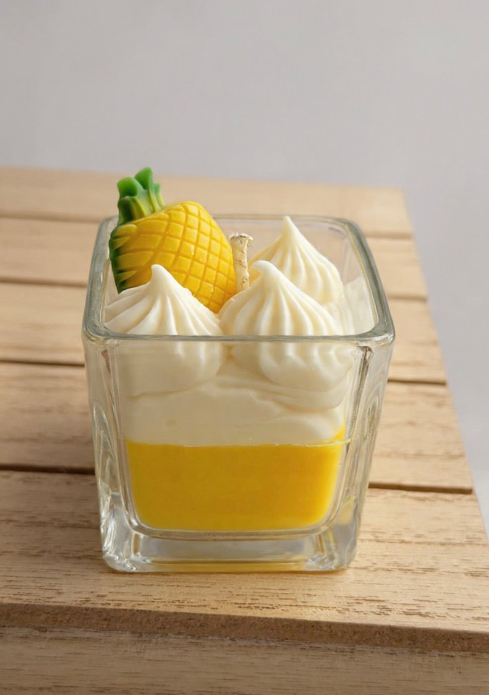 Pineapple Paradise Candle on wooden surface showing yellow and cream layers